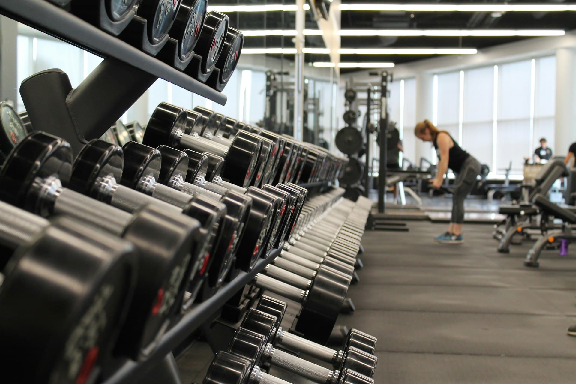 Athletes training with free weights in a modern gym